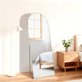 Gold-frame full-length standing floor mirror in a bedroom